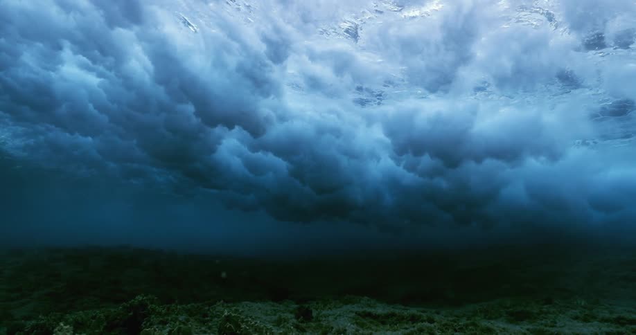 A view from underwater of a wave passing above