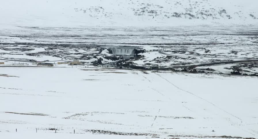 A field is covered with snow below