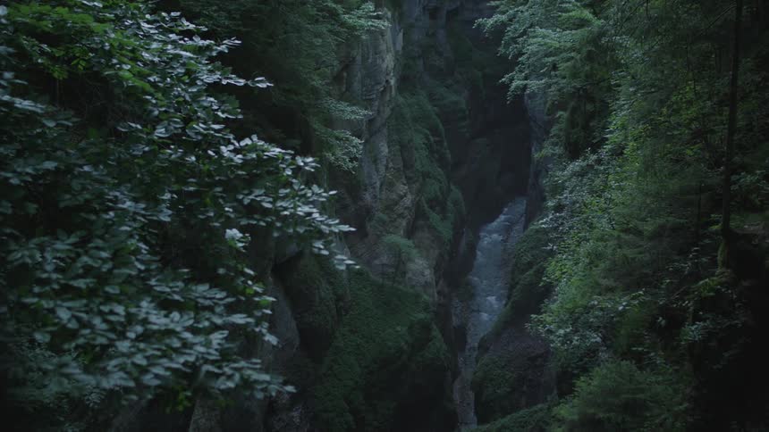The stream runs through the crevice in the mountain