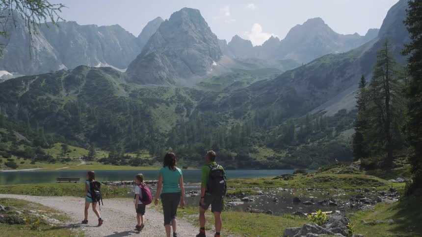 A family are hiking by the mountain