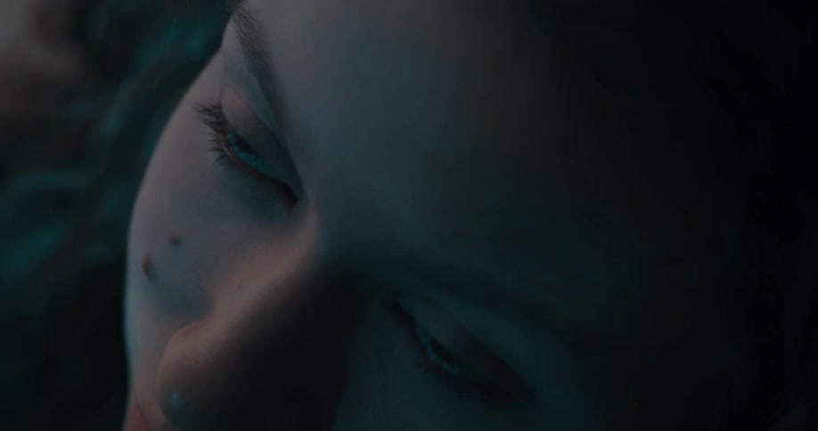 A woman looks up as the light in her room goes off