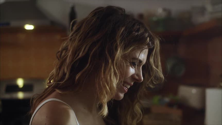 A woman is talking in the kitchen