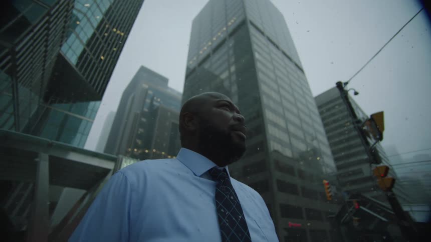 A man standing in a city with snow