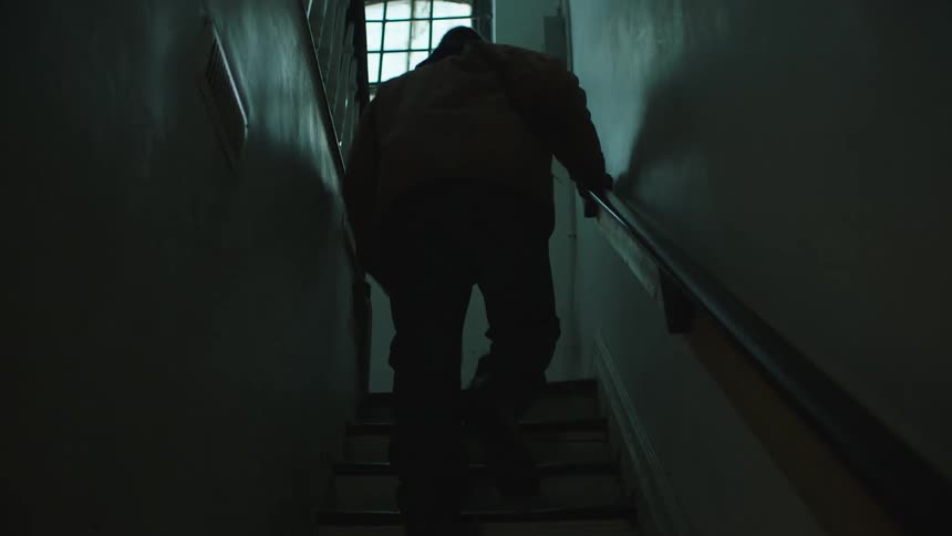 A view of a person walking up stairs