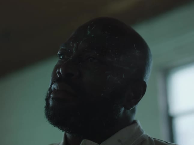 A man sitting in a room during the day