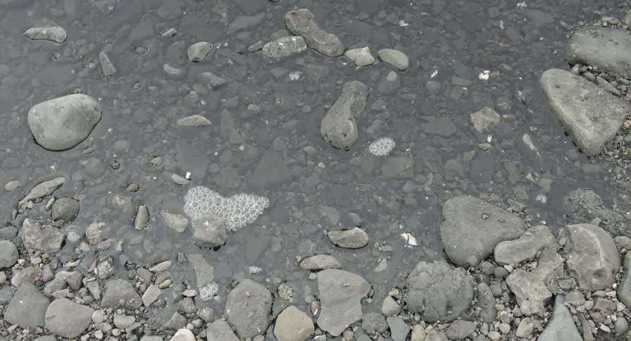 Rising tide swirls over rocks