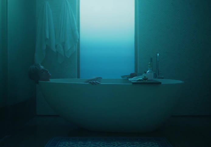 A woman soaking in a large tub looking relaxed