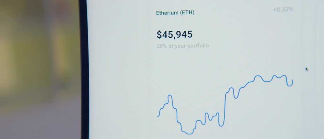 Cryptocurrency graphs on a computer screen scrolling up and down