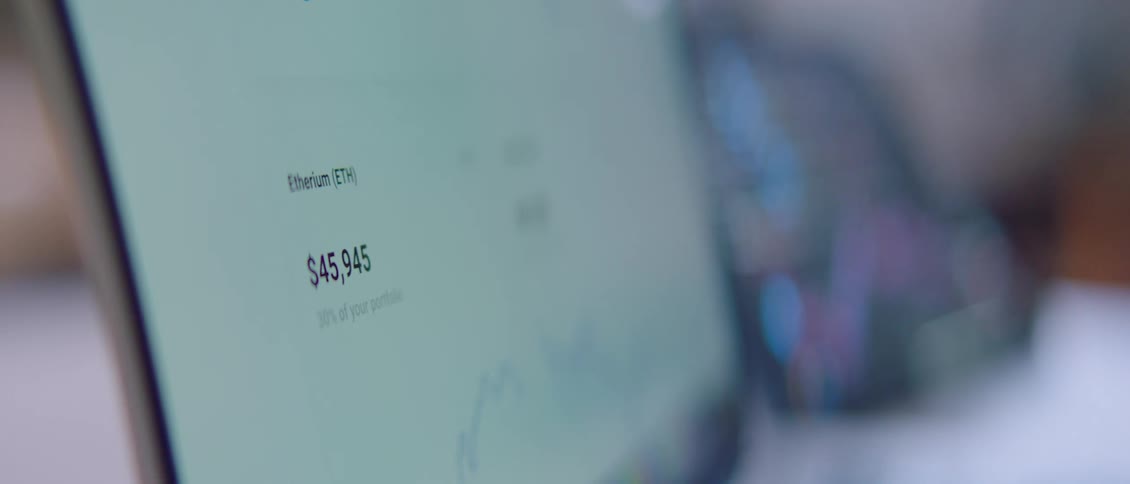 A close view of a computer monitor in an office setting with business data scrolling on the screen
