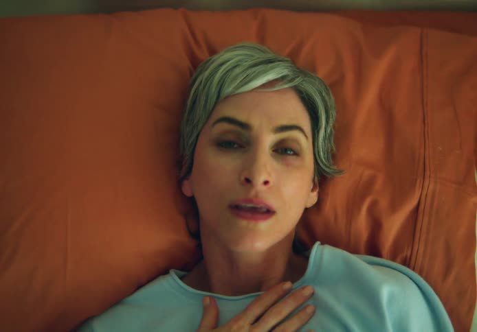 A woman is laying down in her bedroom