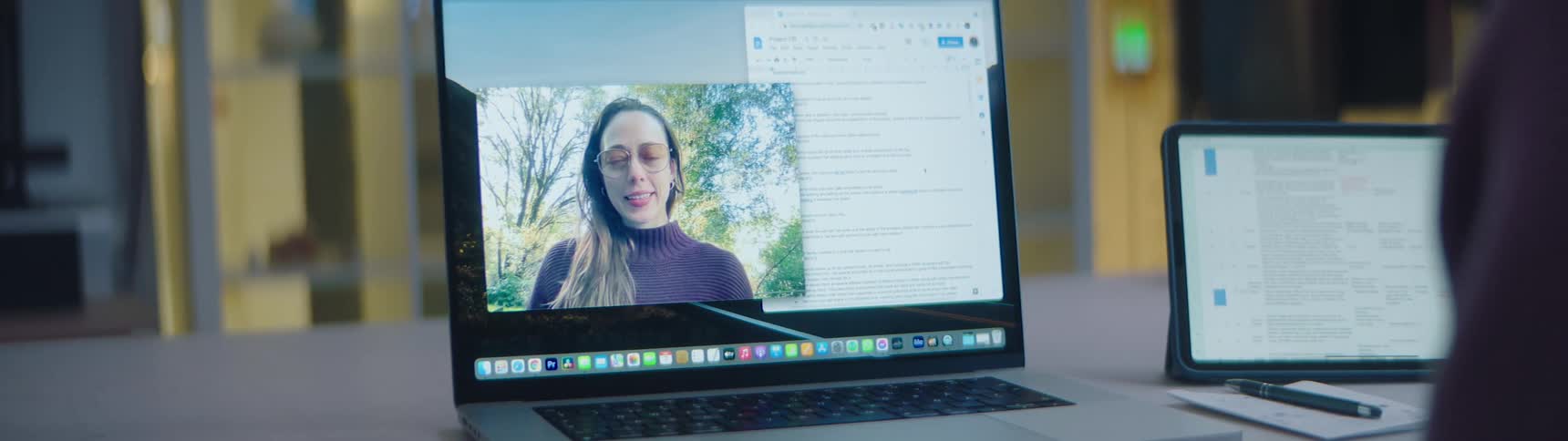 A woman on a laptop screen waves to her counterpart during a video call