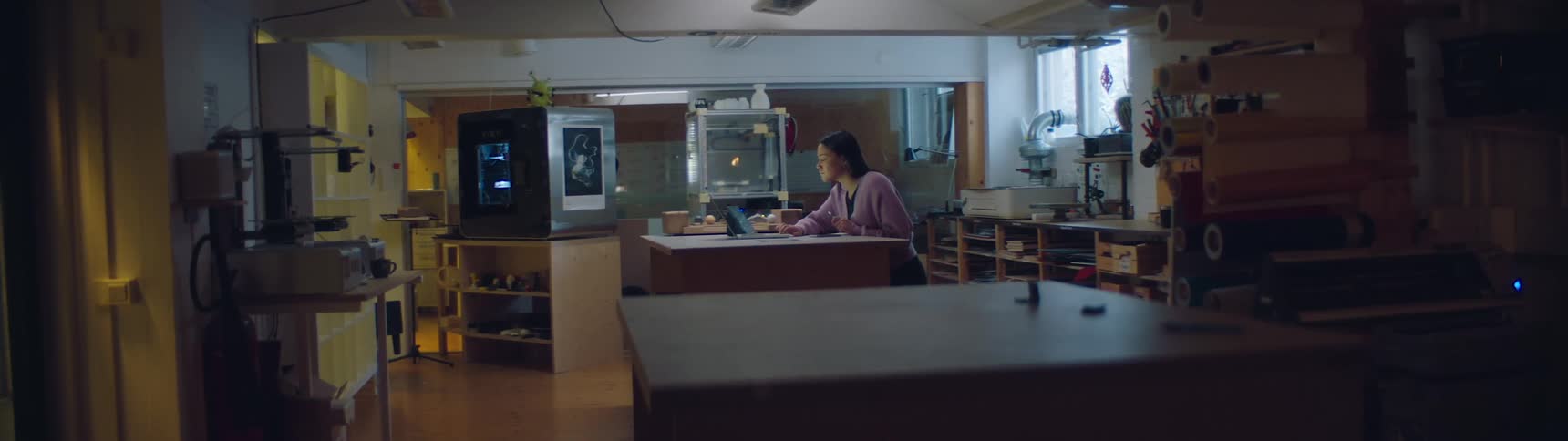 A woman is standing in her kitchen during the daytime
