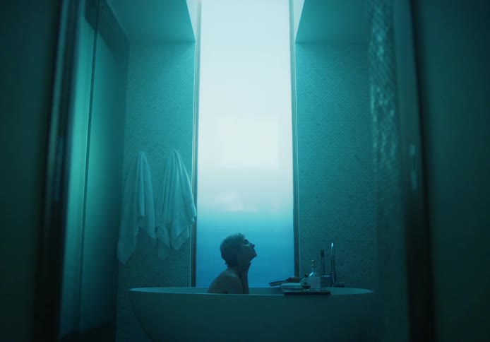 A woman bathes in a tub at home