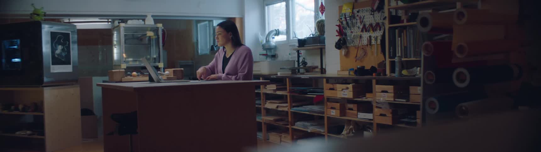 A woman is studying at her house during the daytime