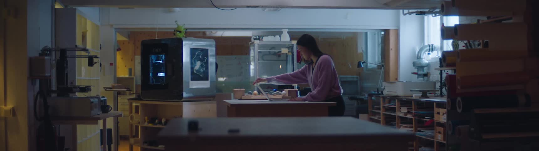 A woman walks into a room and opens her laptop