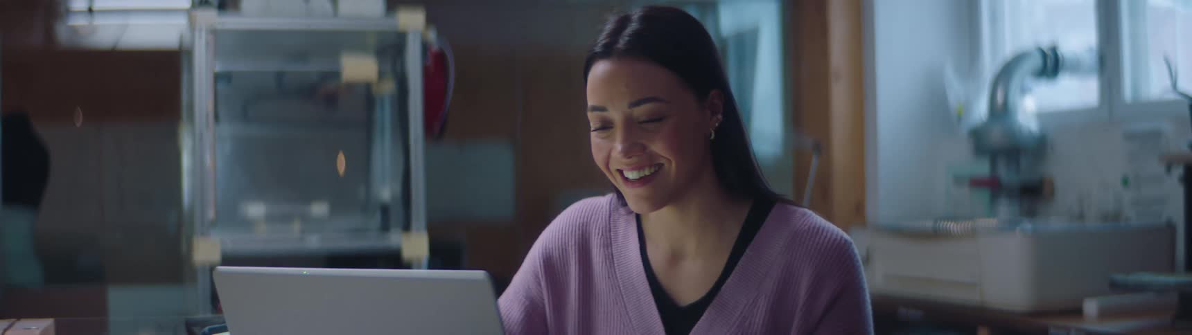 A woman greeting her colleague cheerfully on a video call