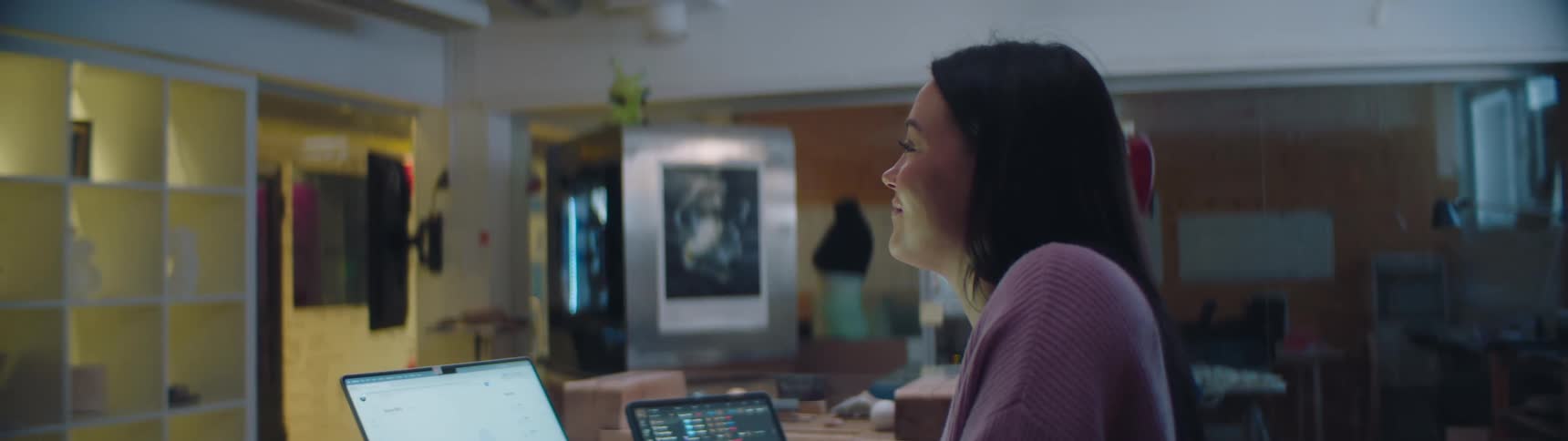 An employee sitting in an office on a computer