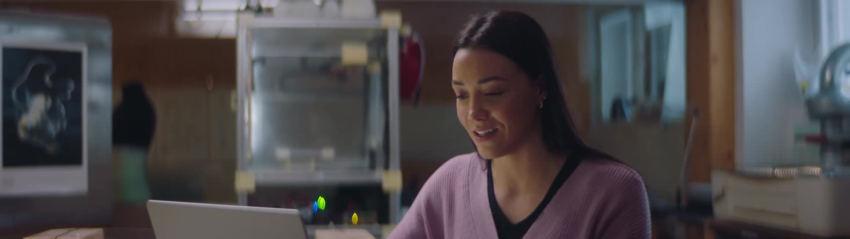 A woman is excitedly talking about something that inspires her during a group video call
