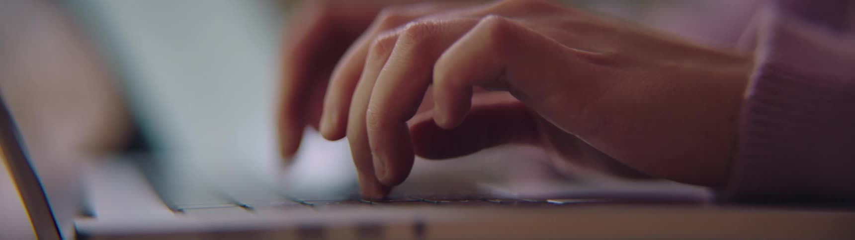A person typing on a laptop