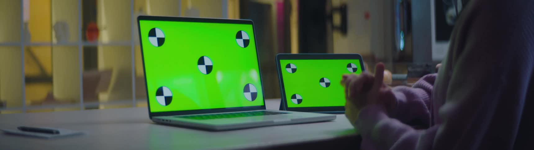 A person is using a tablet and laptop