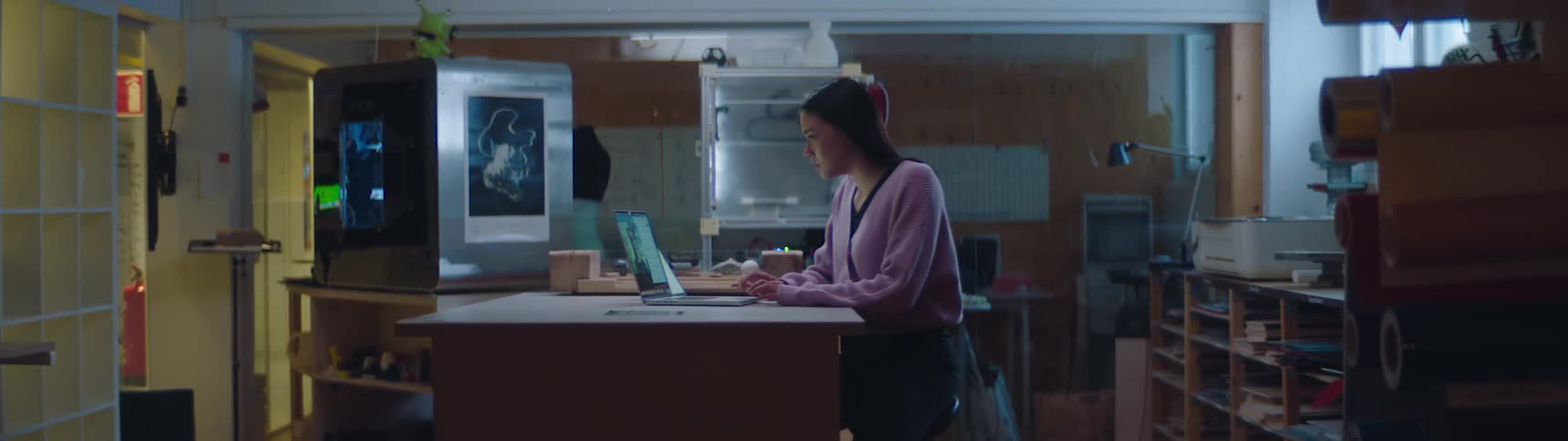 A woman is working in the office while on a video call