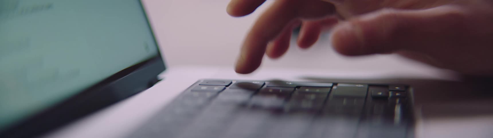 A person is typing keys on a computer keyboard