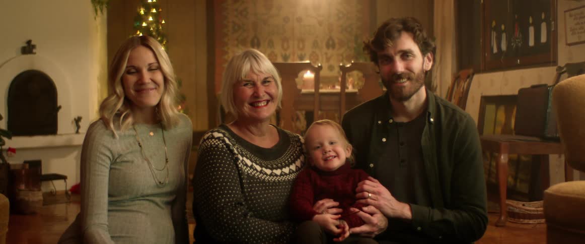 A family is taking a family photo together indoors