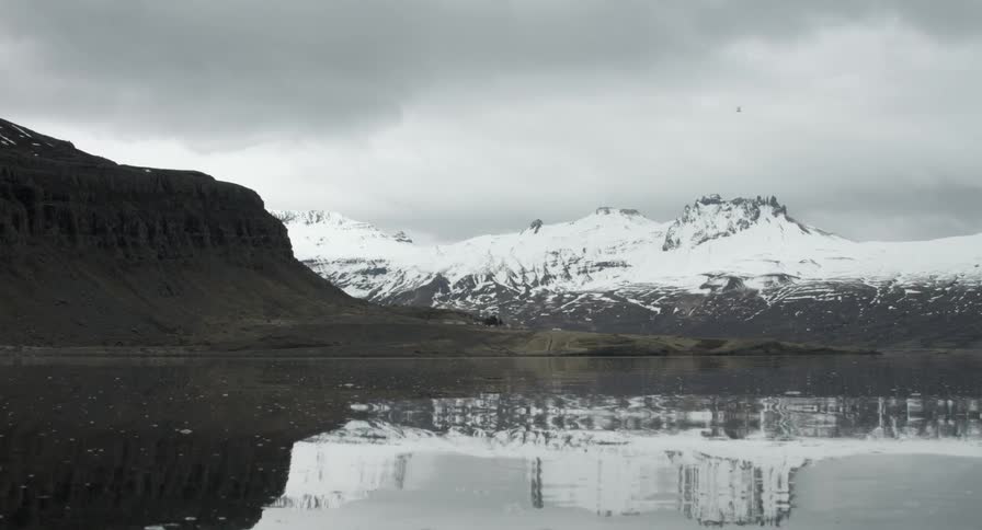 Water sways in front of a mountain