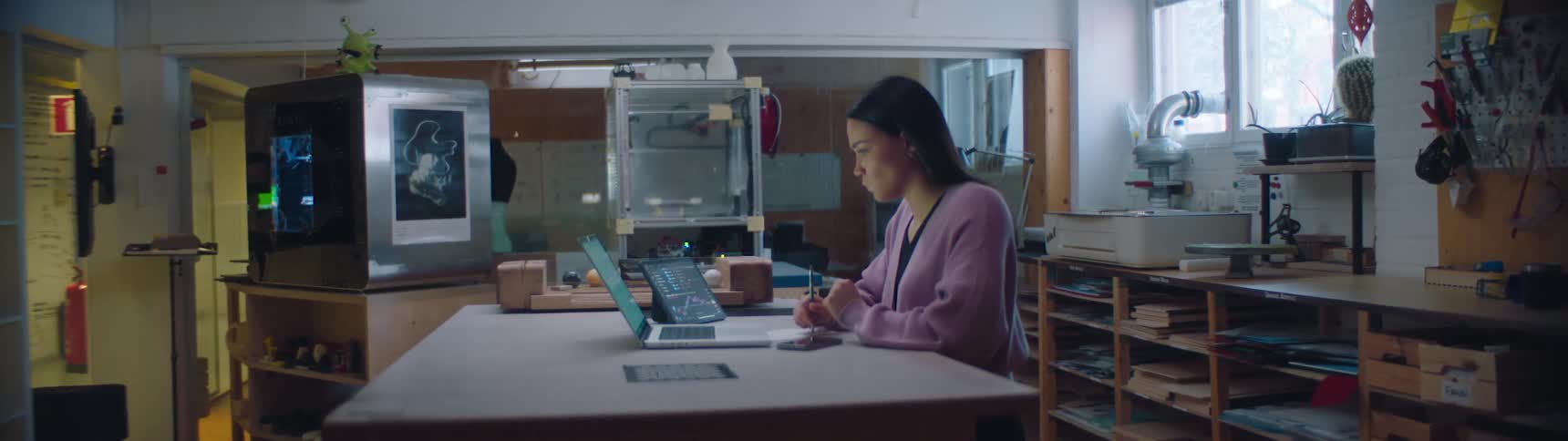 A woman is working at the desk