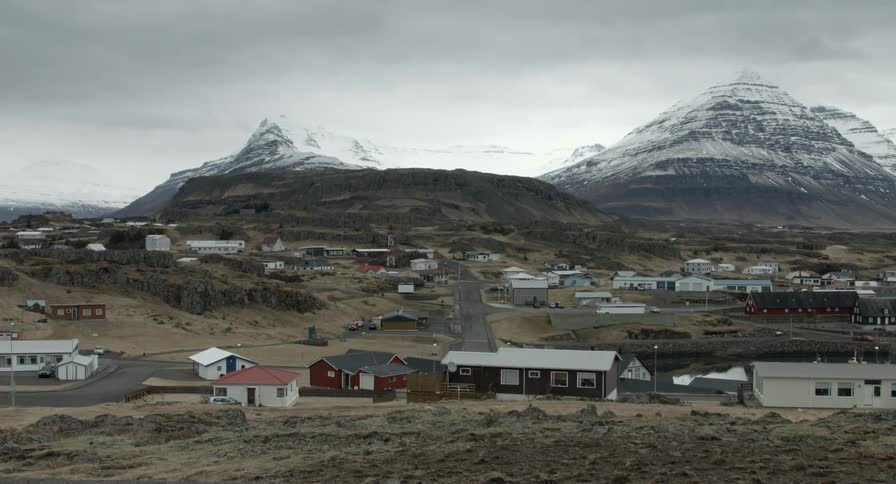 A small city sits at the base of a mountain