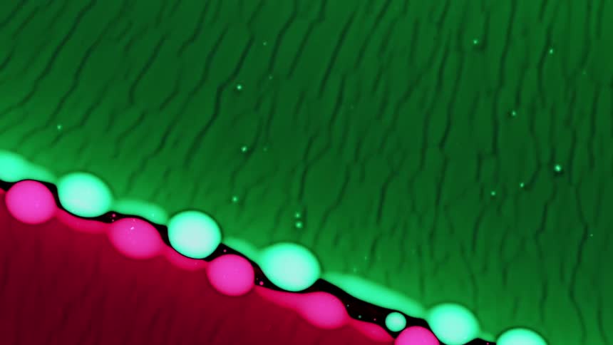 Pink and green spheres meet in the middle to form a design