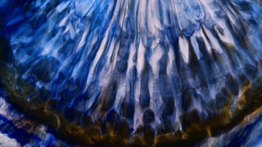 A ring of blue and white colors with a touch of yellow blend as they move upward towards the light
