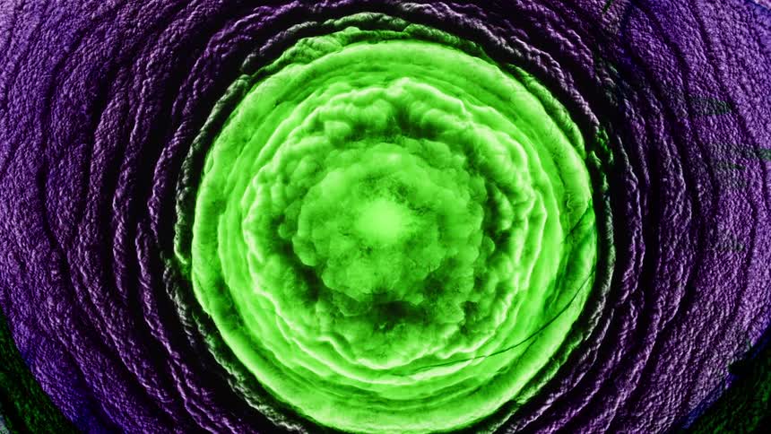A bright green portal emerges from a circle of purple cloudlike rings