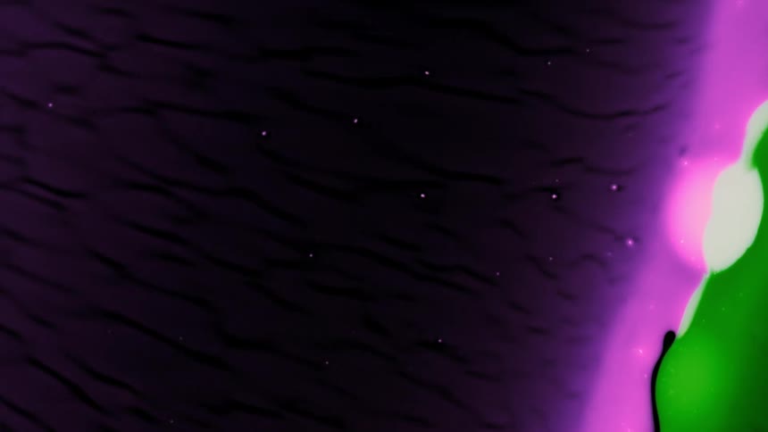 A wall of small white dots in the blackness rotates and becomes pink green and purple dots moving together in the center