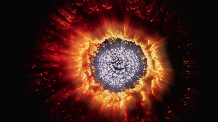 A sunburst of deep red and orange with the light colored center shrinking and becoming a black hole
