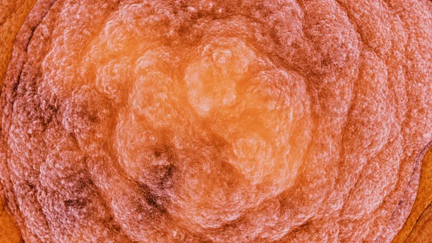 Orange circles of clouds vibrate out from the center and the edges become white