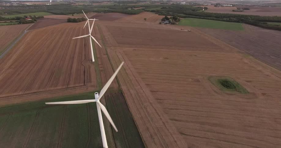 Aerial view of a farm with wind turbines