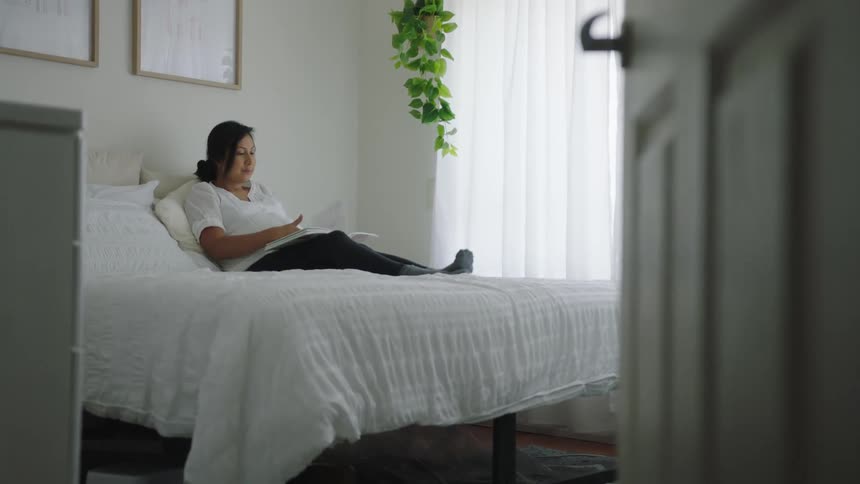 A woman reads in bed