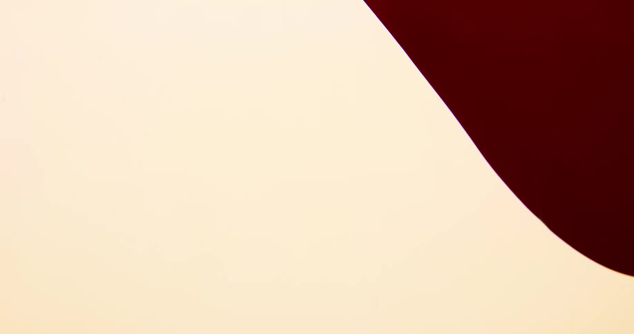 Abstract footage of paint flowing on a cream background