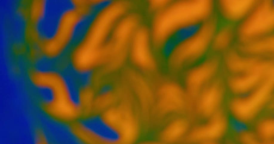 A blue and orange work of art with green highlights twists and becomes blurry
