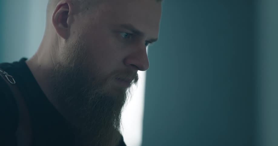 A man is in a room and concentrating on something