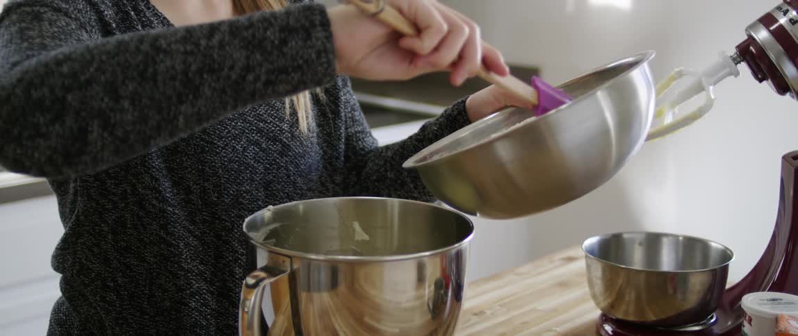 Woman pouring flour into a mixing bowl