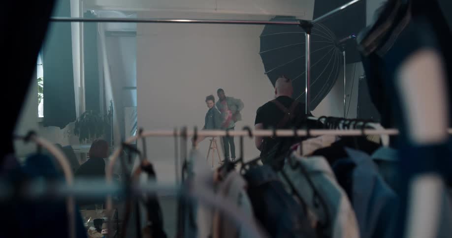 Photographer takes pictures of fashion models in photo studio