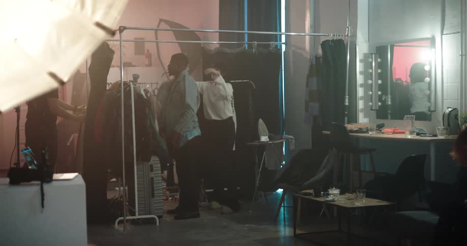 A woman dresses a model in the dressing room