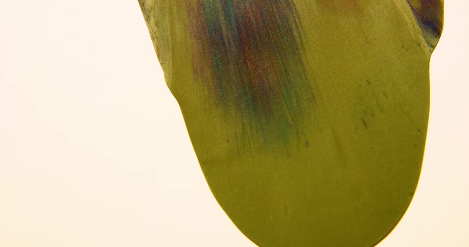 Yellow liquid flowing over a white surface
