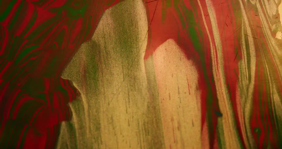 A painting made of red green and gold gets wiped away down the middle