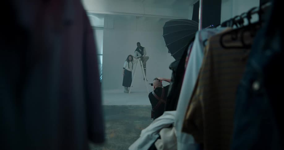 Photographer takes pictures of models during a photo shoot