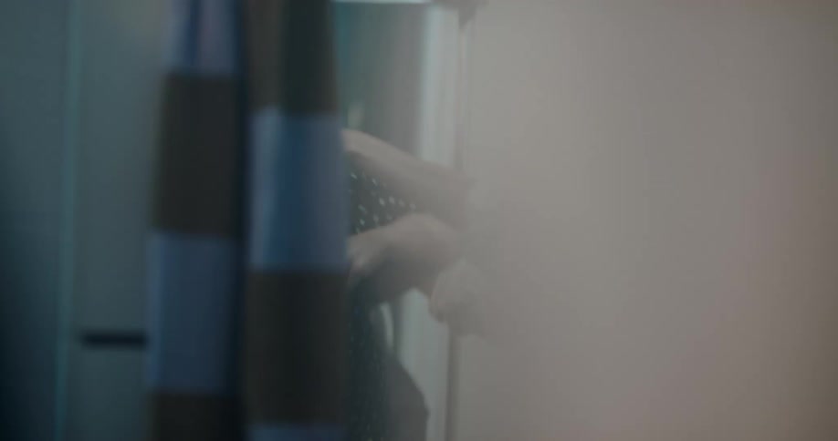 Two women are trying on clothes near a mirror