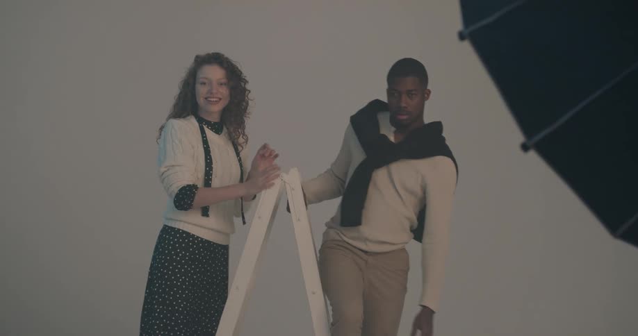 A man and woman are posing for a photo shoot