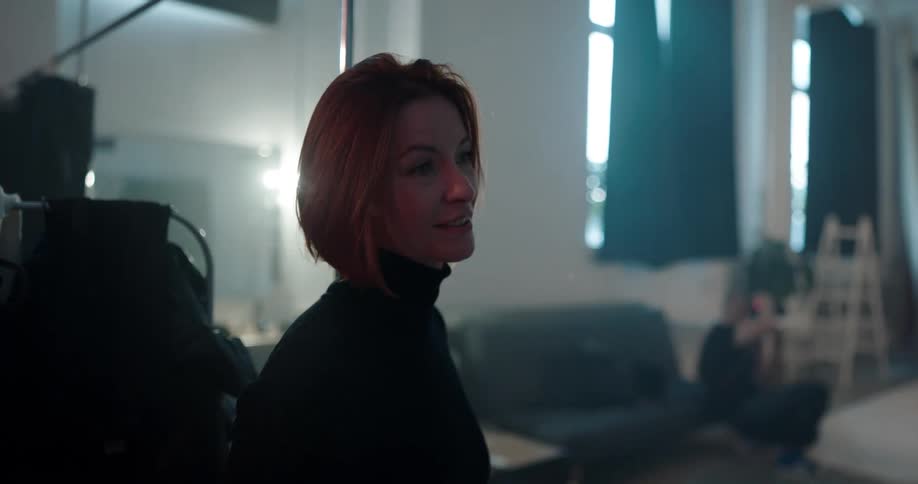 A woman talks with someone during a photoshoot